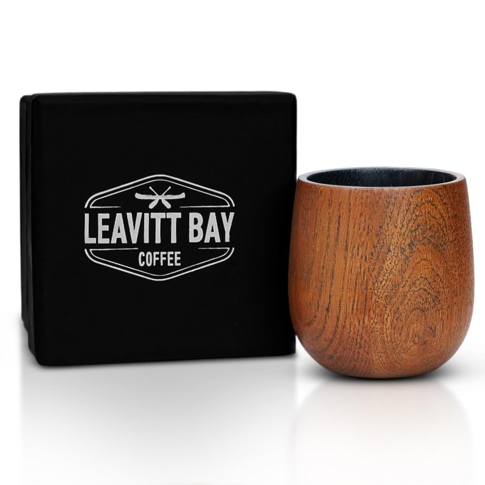 Wooden coffee cup and black box with Leavitt Bay Coffee logo on a white background